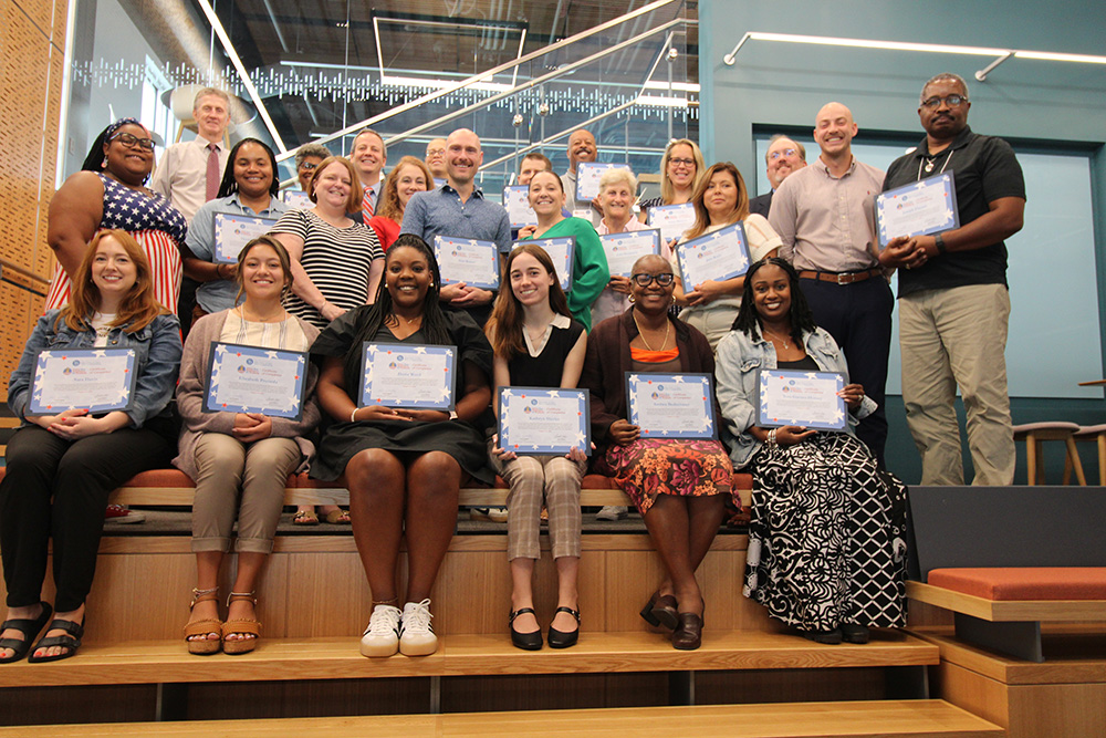 Portrait featuring teachers/participants of the 2024 Civics that Empowers All Students Program holding up their certificates