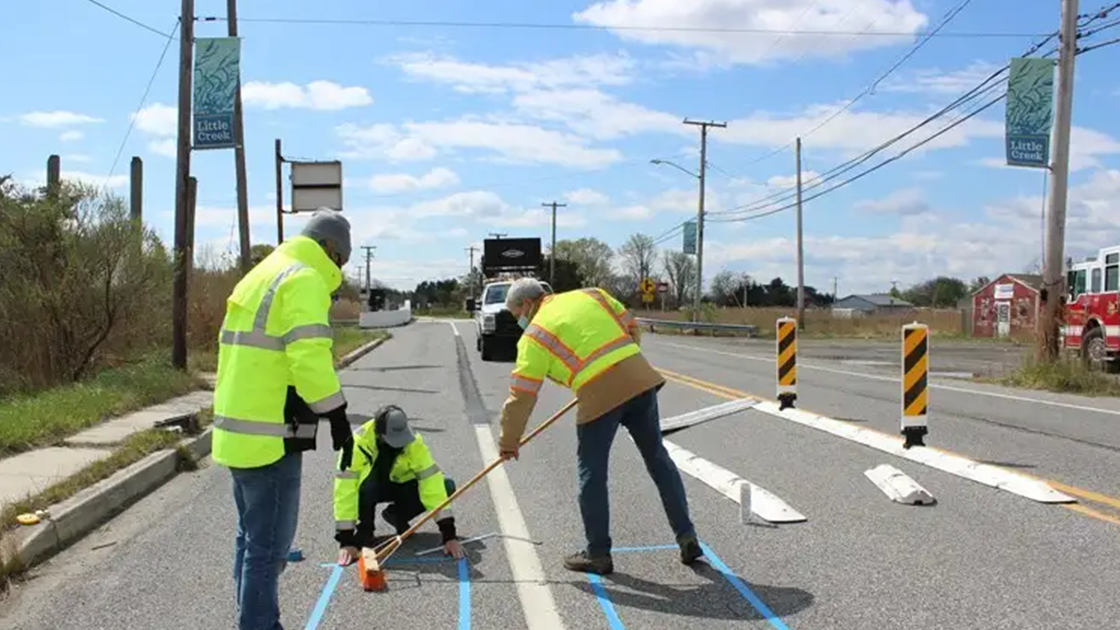Engineers painting a roadway 