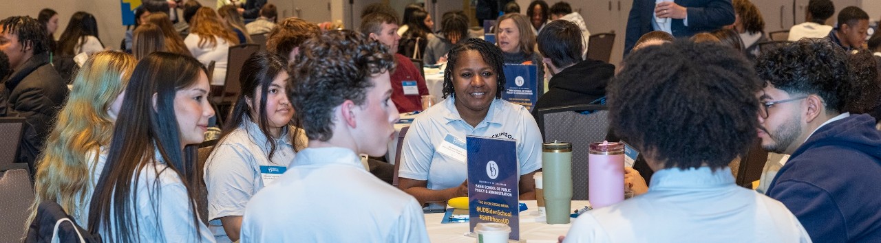 Students talking around a table at DE Dialogues