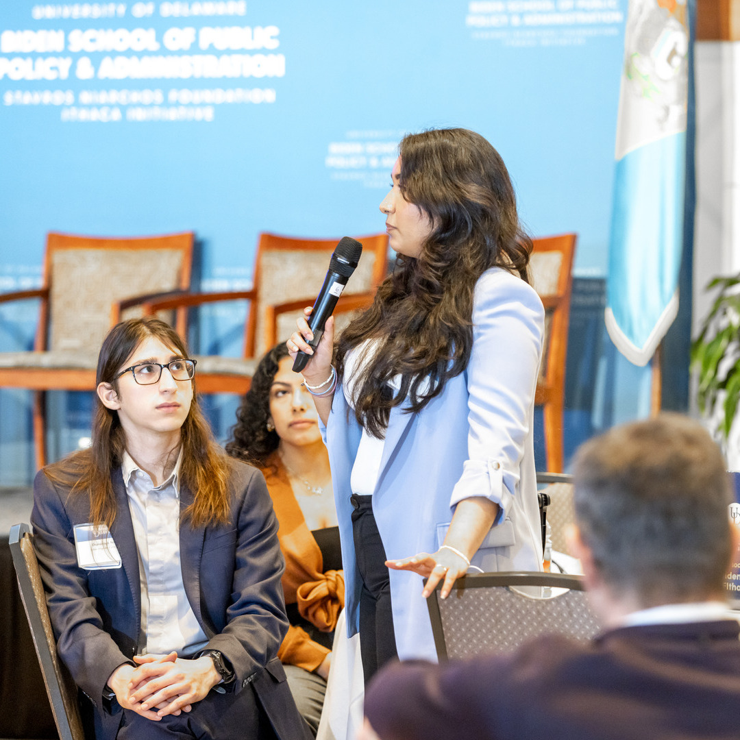 Photo of student attendees listening to a peer sharing their thoughts while holding a microphone at the 2024 SNF Ithaca National Student Dialogue