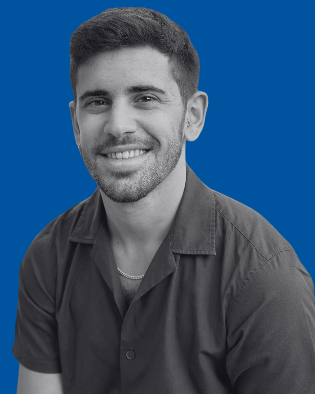 A black-and-white portrait of a person against a solid blue background