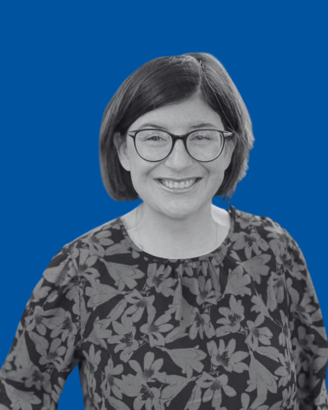 A black-and-white portrait of a person against a solid blue background