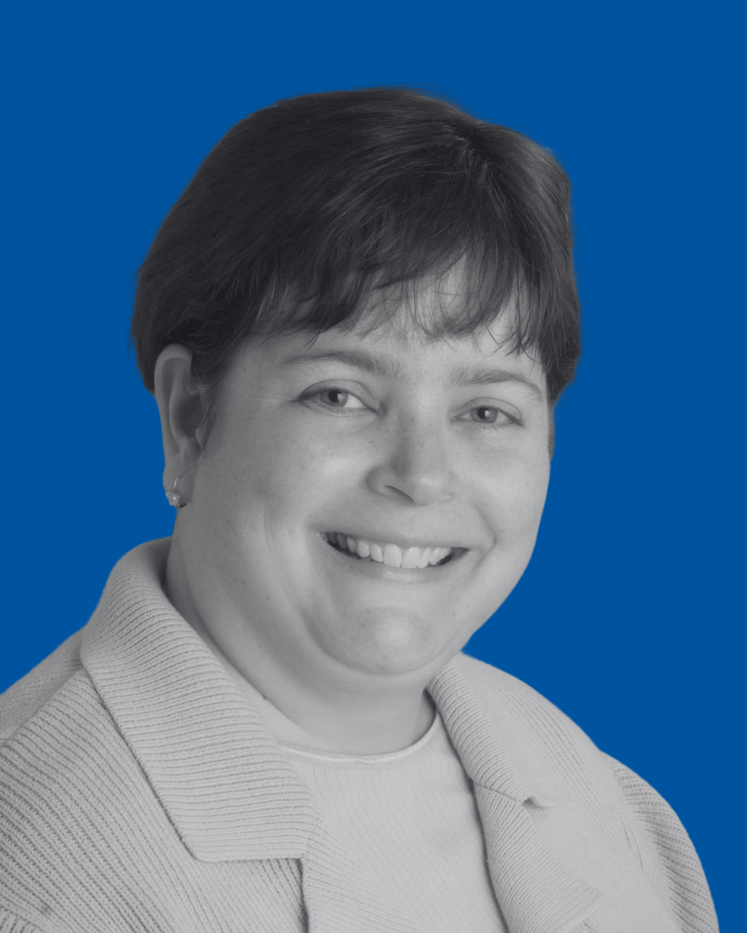 A black-and-white portrait of a person against a solid blue background