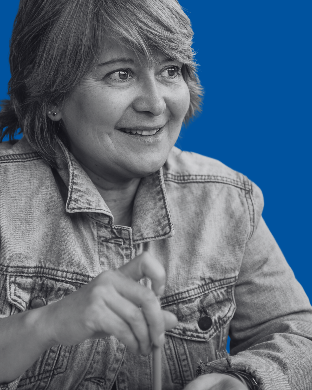 A black-and-white portrait of a person against a solid blue background