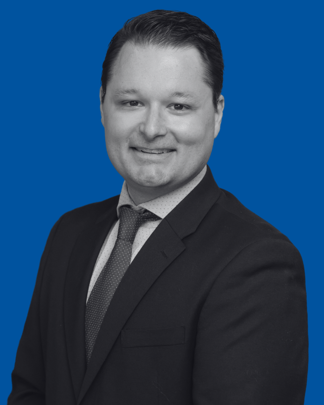 A black-and-white portrait of a person against a solid blue background