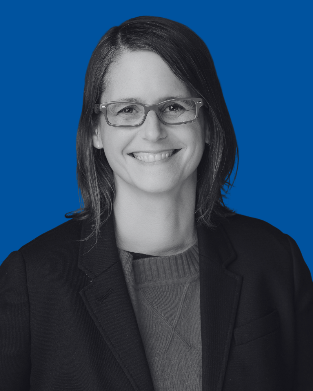 A black-and-white portrait of a person against a solid blue background