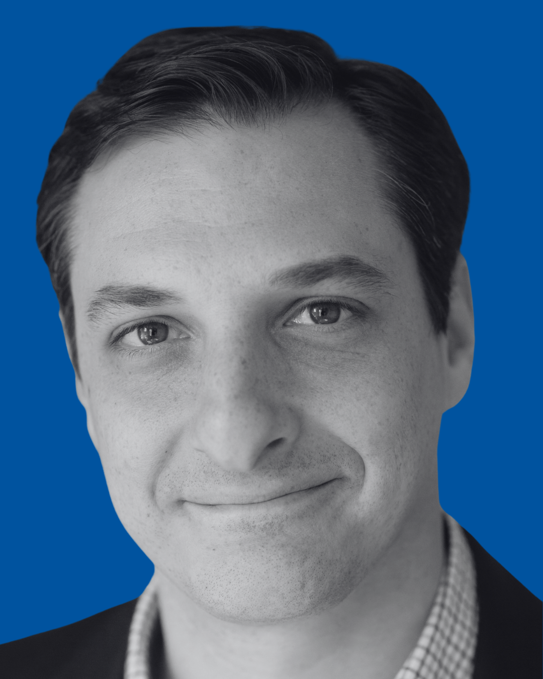 A black-and-white portrait of a person against a solid blue background