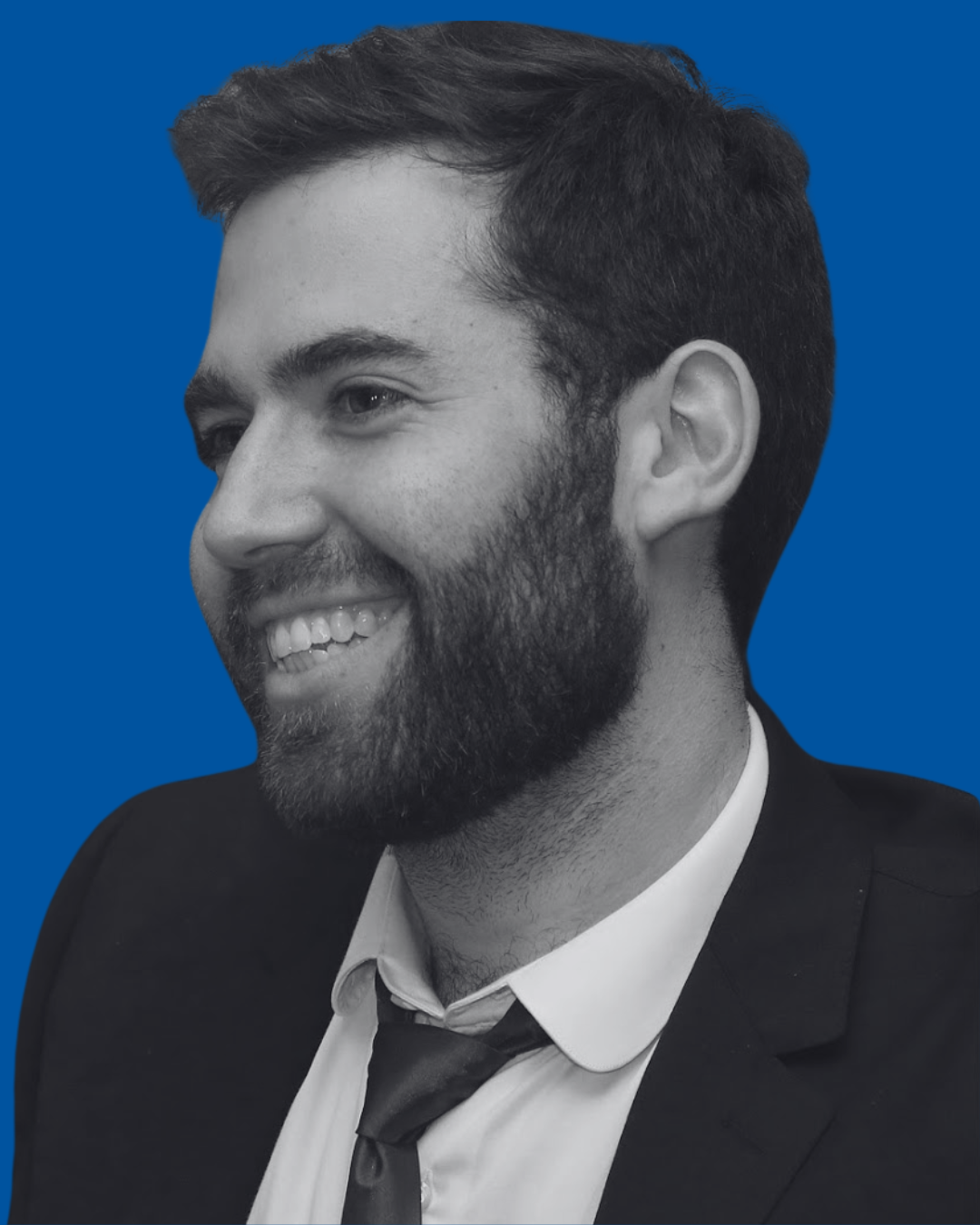 A black-and-white portrait of a person against a solid blue background