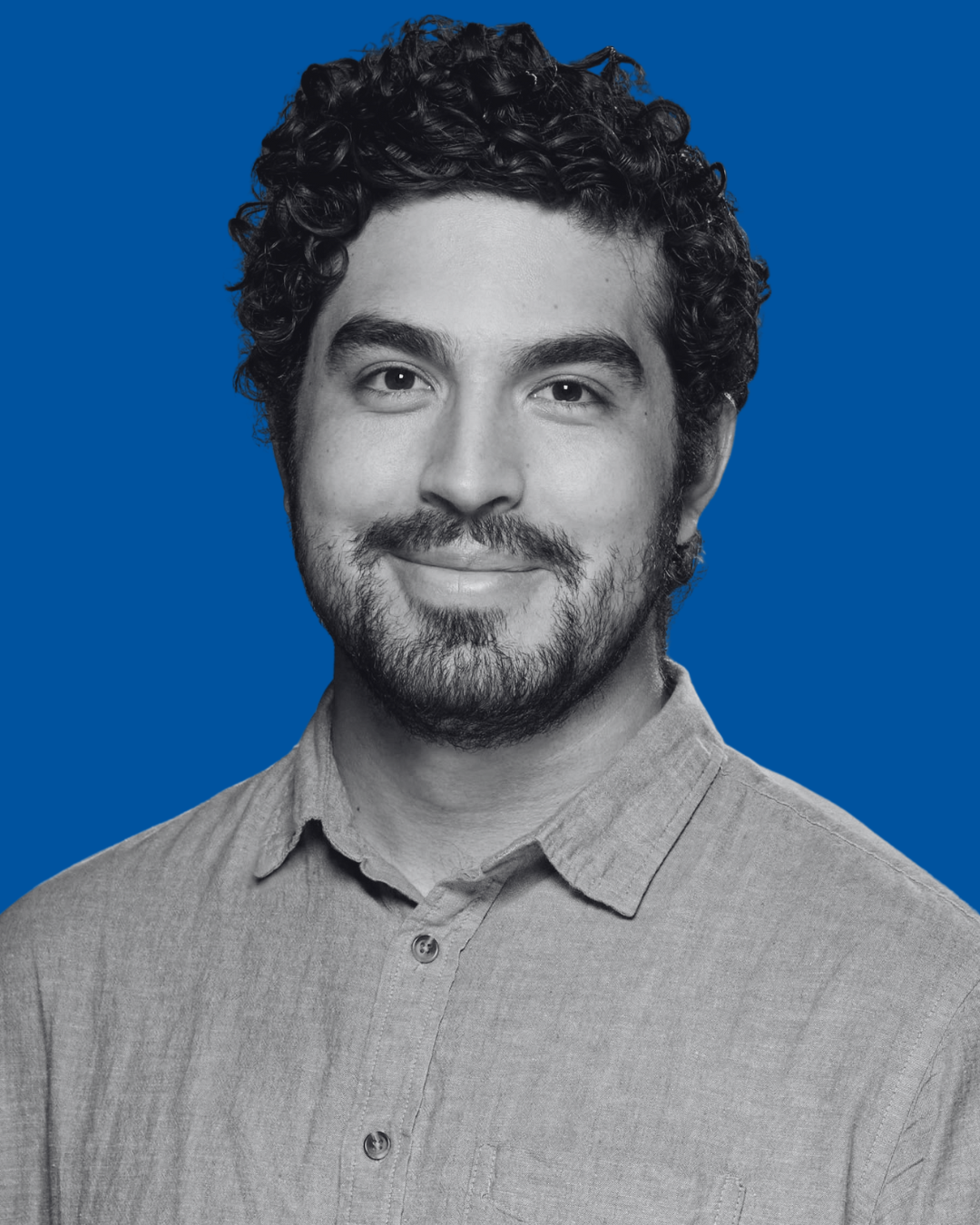 A black-and-white portrait of a person against a solid blue background