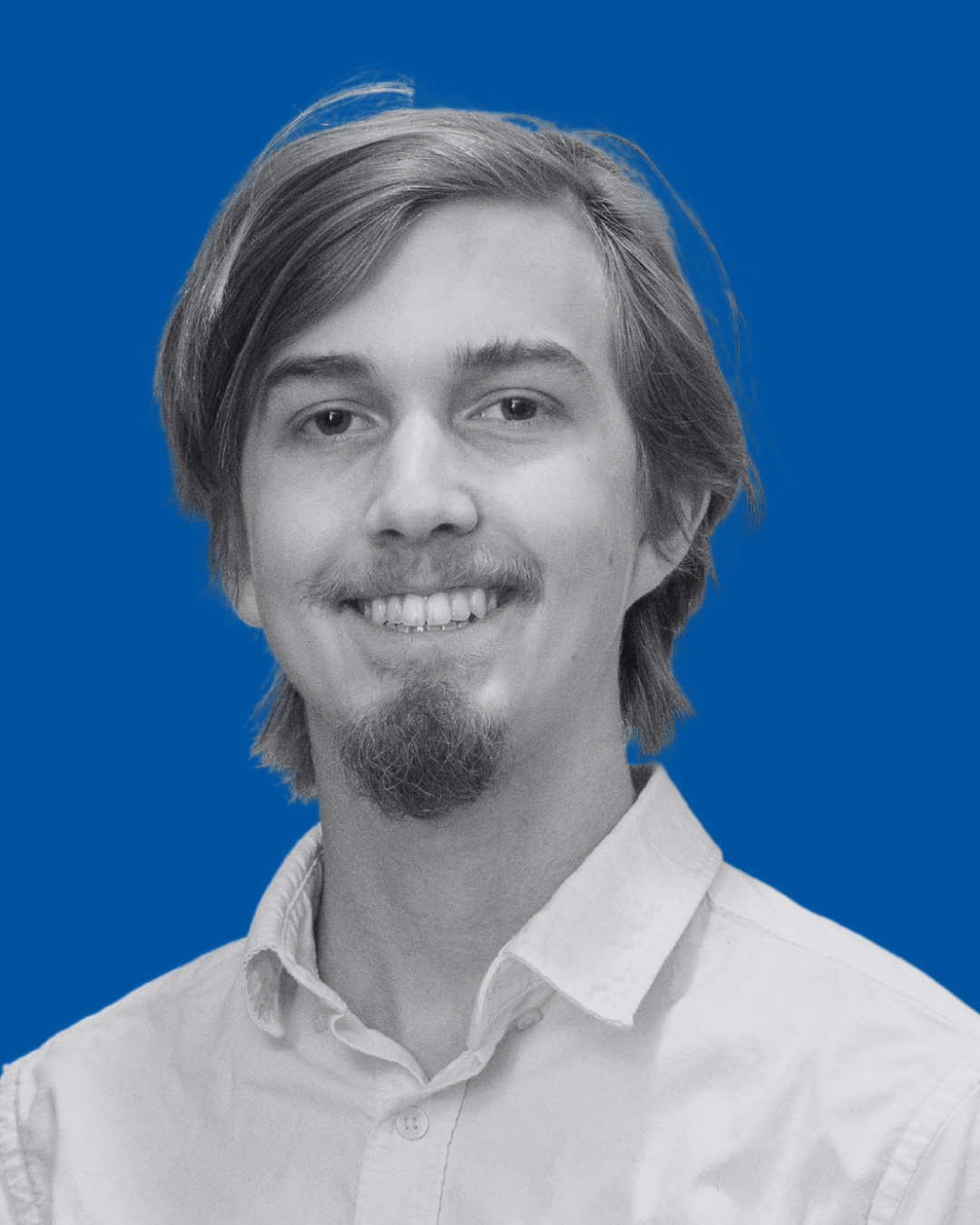 A black-and-white portrait of a person against a solid blue background
