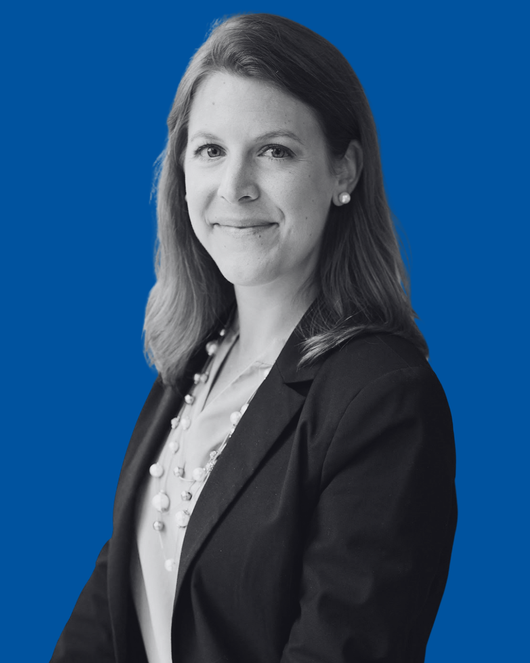 A black-and-white portrait of a person against a solid blue background