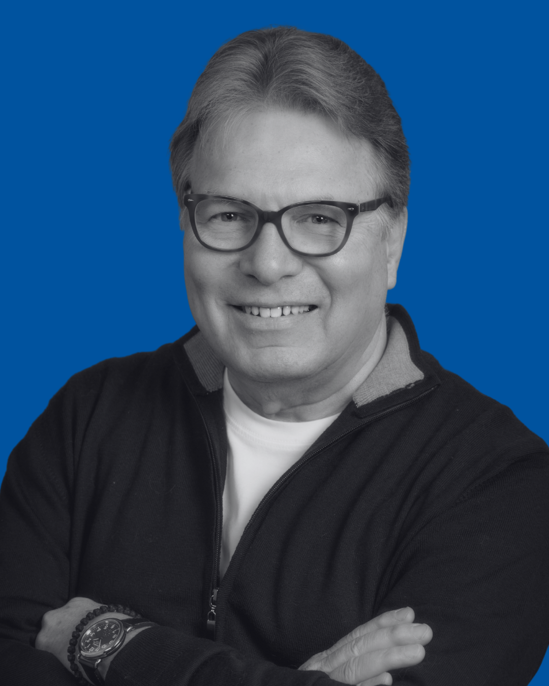 A black-and-white portrait of a person against a solid blue background