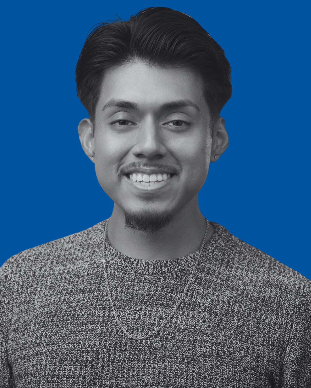 A black-and-white portrait of a person against a solid blue background