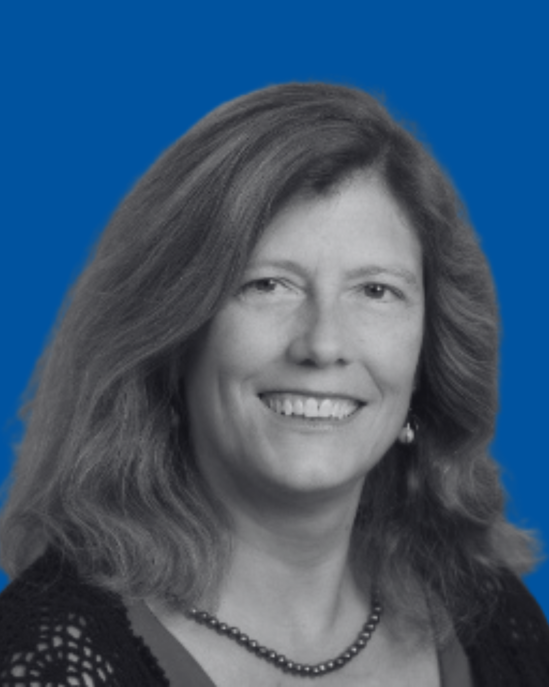 A black-and-white portrait of a person against a solid blue background