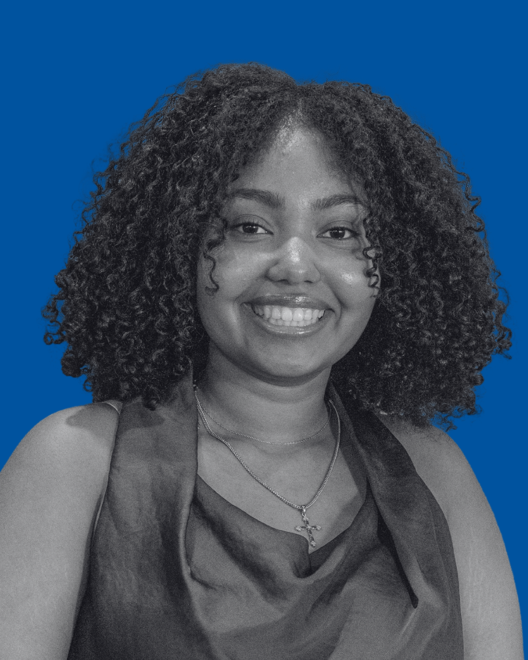 A black-and-white portrait of a person against a solid blue background