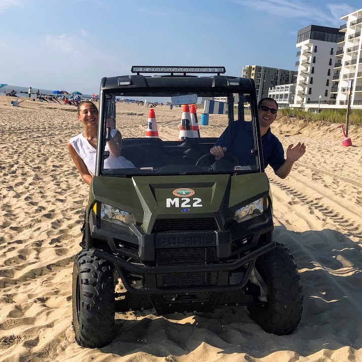 Fellows Driving a Gator on the Beach