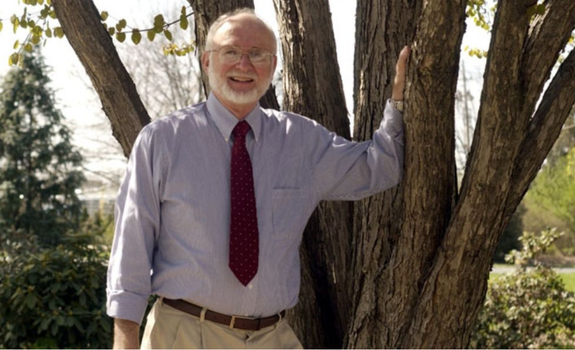 Dr. Roland Roth posing in Ecology Woods.