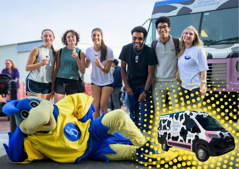Front of the UDairy Creamery Moo Mobile with three student employees