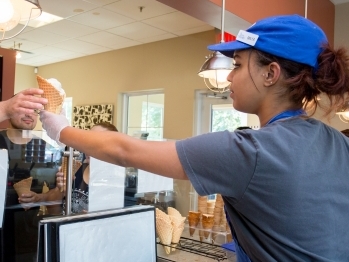 _float_extension_350x400 - 2 A student handing freshly-scooped ice cream to a customer.
