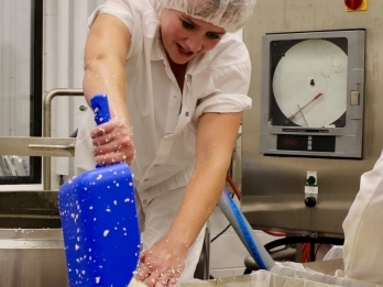 _float_extension_350x400 - 1 A woman transfers cheese into cheescloth.
