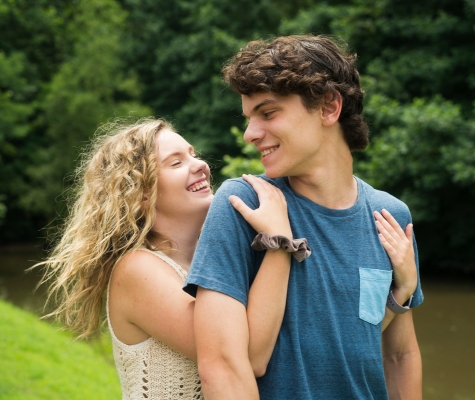 A male and female teen being affectionate A male and female teen being affectionate