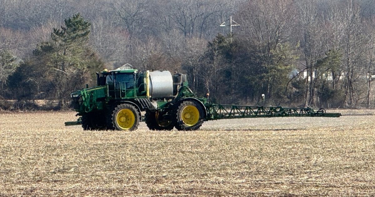 lime1 - 1 A tractor in a field applying lime