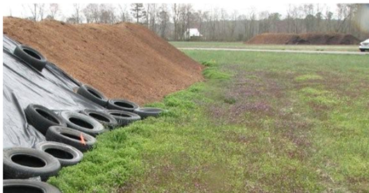 lit11 - 1 Figure 1. A stockpile of litter that is in the process of being covered. (Photo credit: Nutrient Management Program, University of Delaware).