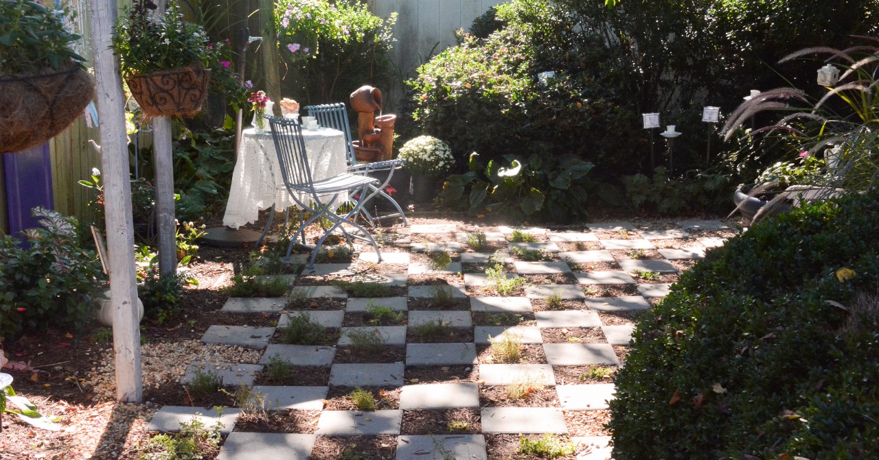 garden seating area with checkered stone paver floor