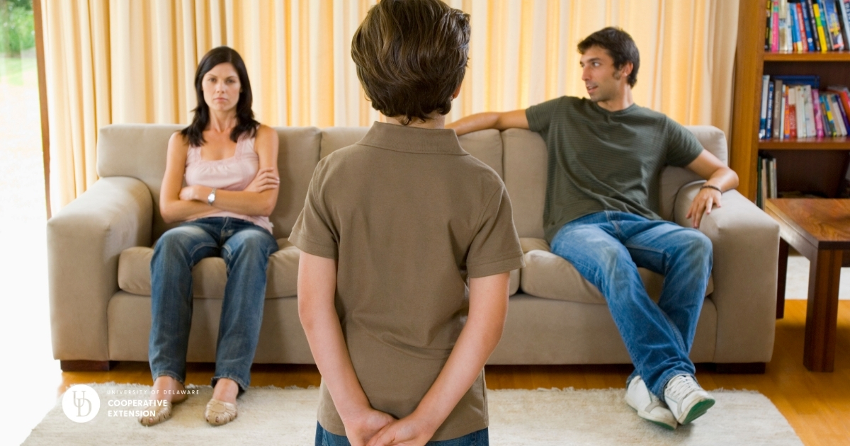 Two parents on the couch facing a child as he listens Two parents on the couch facing a child as he listens