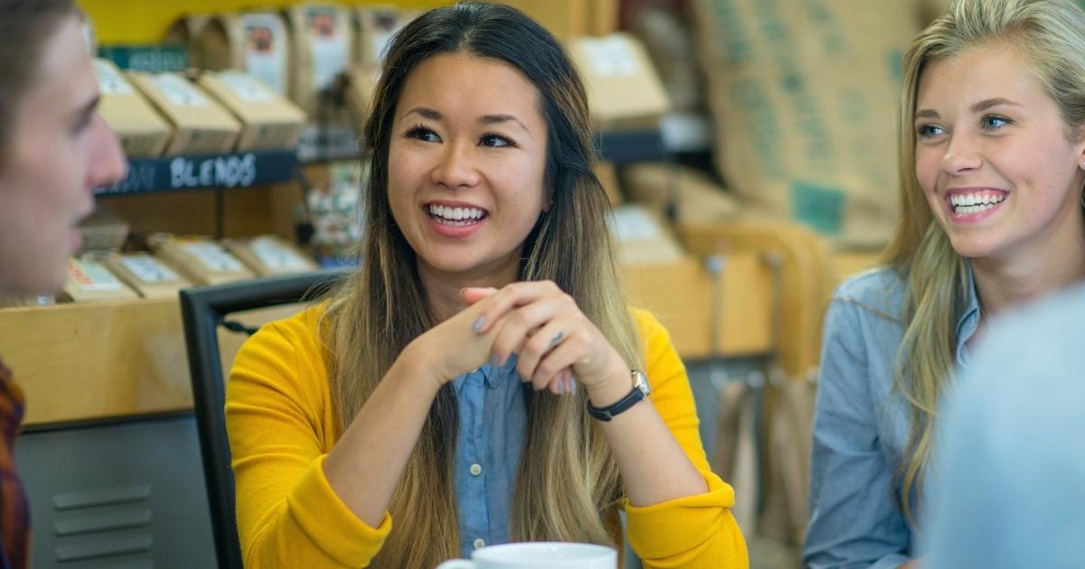 Two women having coffee with friends.