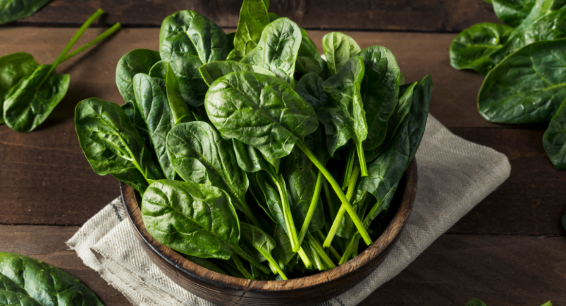 Spinach leaves in a bowl on a table
