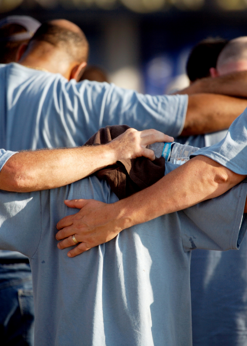 spiritual_wellness_extension_img A group with arms around each other in prayer.