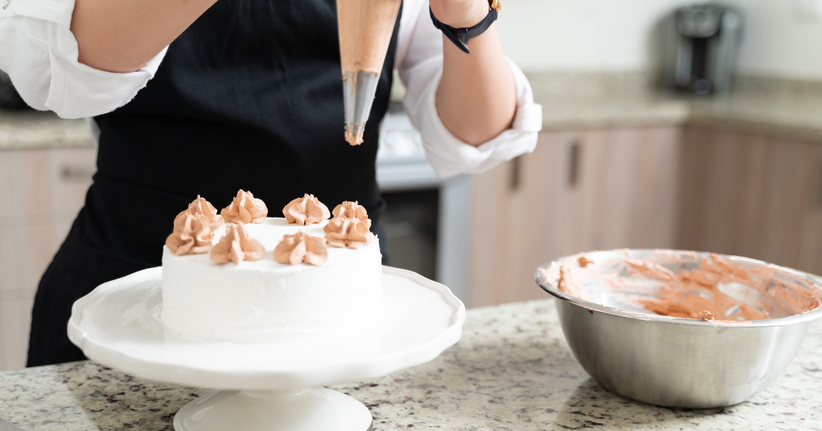 A home baker decorating cakes for sale