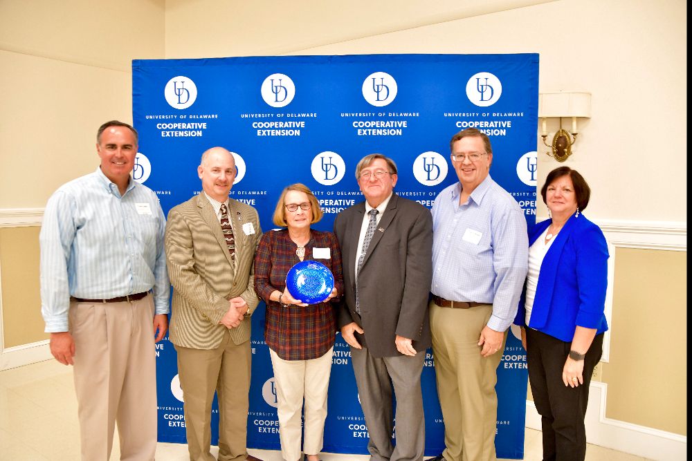 Ernie Lopez (far left), Doug Crouse (second from right) and Michelle Rodgers (far right) present a Friends of Extension award to Joseph Poppiti, Laura Hill and Richard Wilkins of Delaware Farm Bureau.