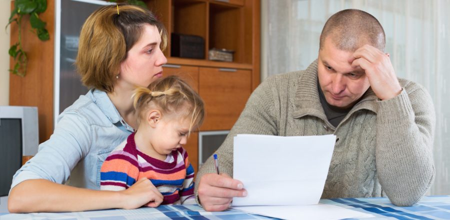 A family struggling with their budget at the kitchen table.