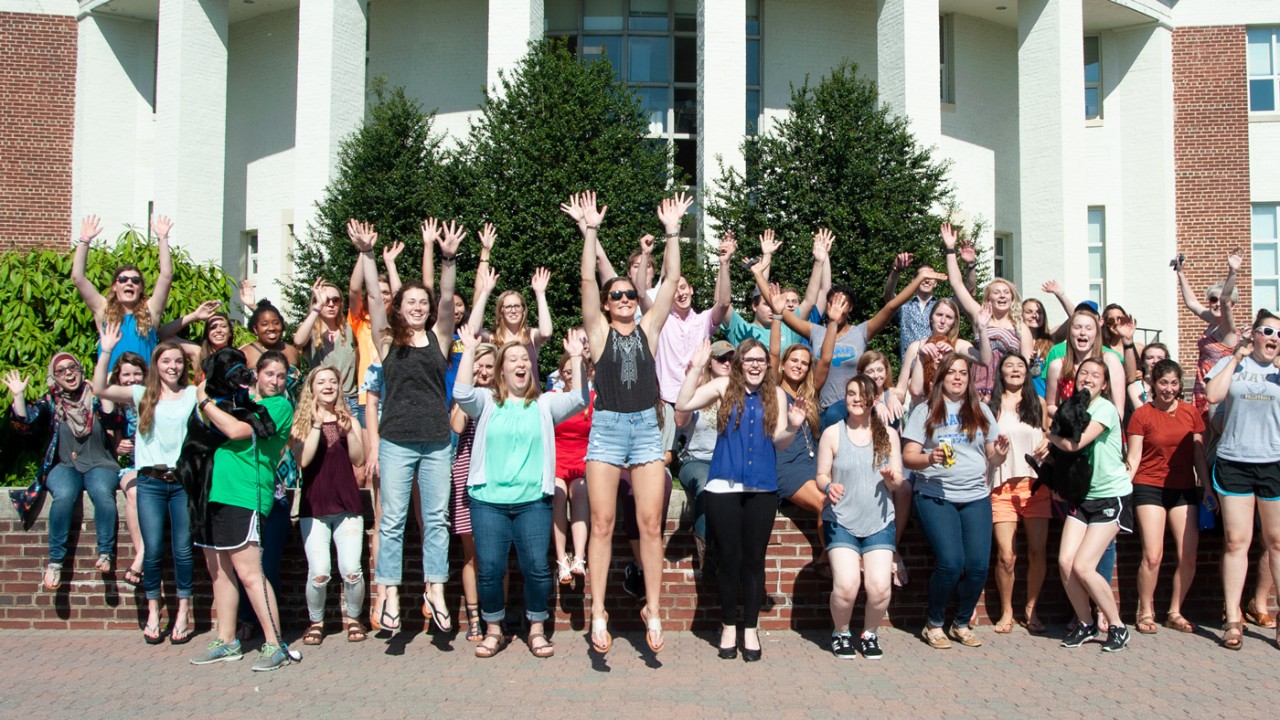 Ag Ambassador student group excited outside of Townsend Hall on South Campus.