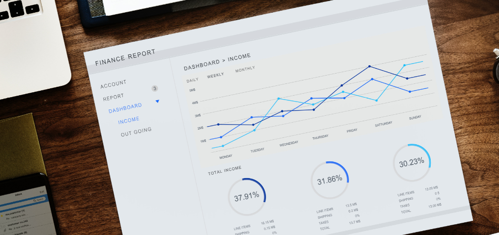 Desktop with laptop and financial report