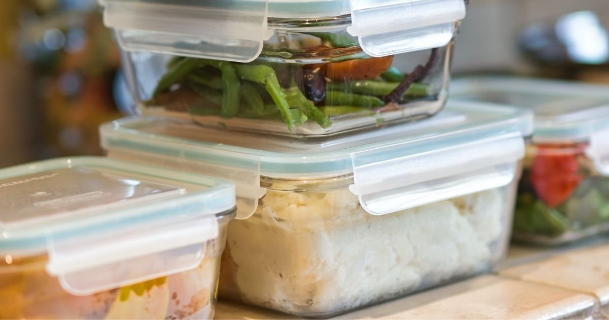 A stack of glass tupperware with leftovers.