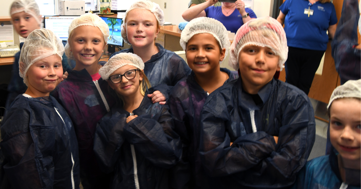 Campers dressed in scrubs prepare for a laboratory tour during Sussex County's 4-H Extension Day Camp in 2019