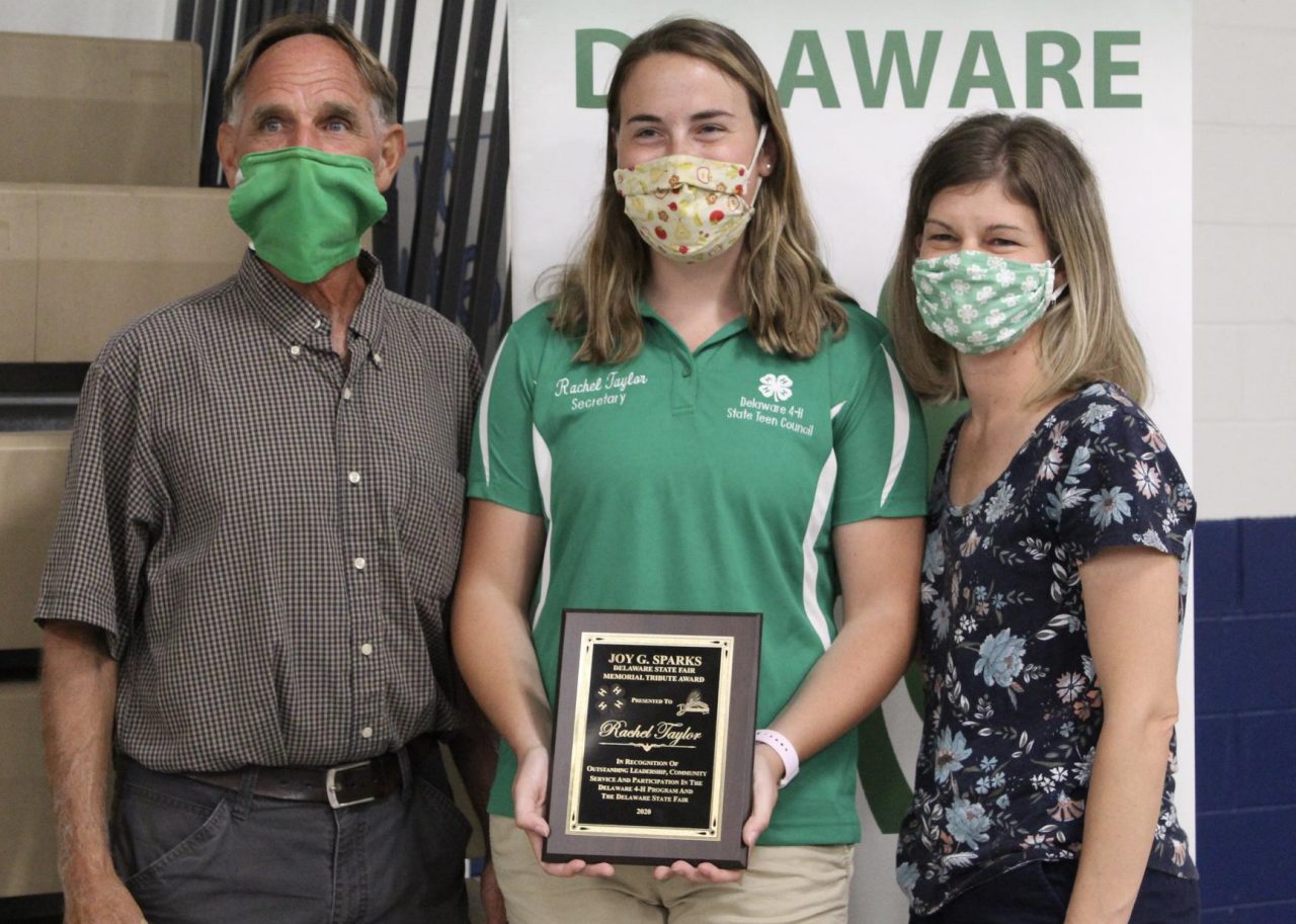 Rachel Taylor poses with her award standing between Alex Gooden and Lindsay Hughes. 