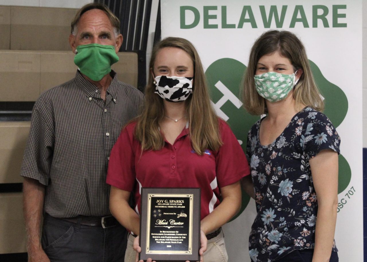 Maci Carter poses with her award standing between Alex Gooden and Lindsay Hughes. 