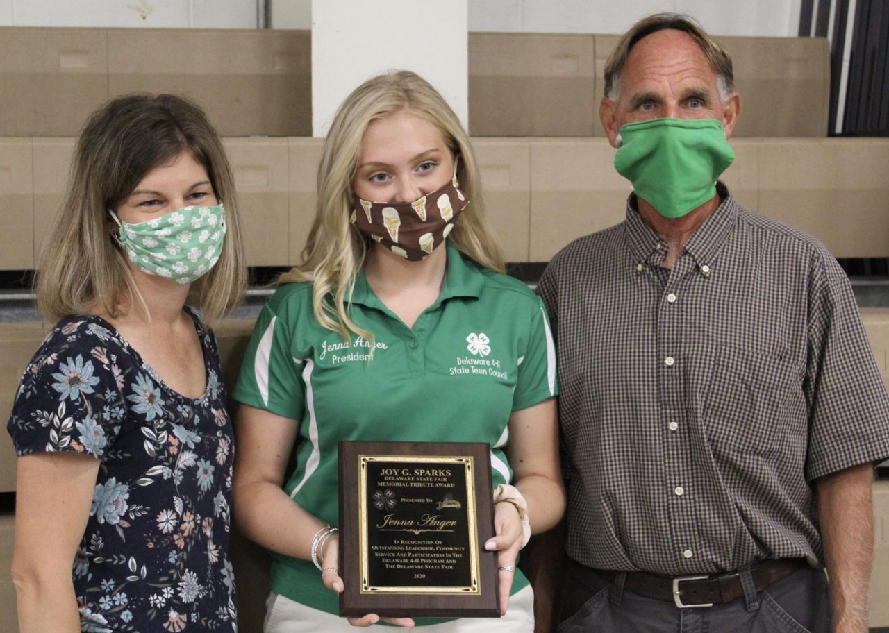 Jenna Anger poses with her award standing between Alex Gooden and Lindsay Hughes. 