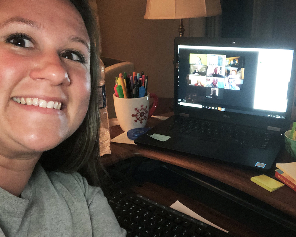 Kaitlin Klair, 4-H Program Coordinator, smiles for a photo with the campers on Zoom in the background.