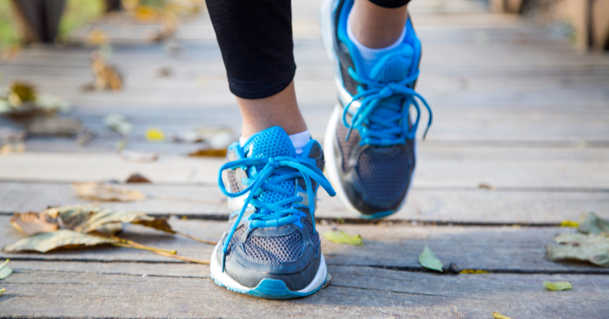 A person in sneakers walking forward