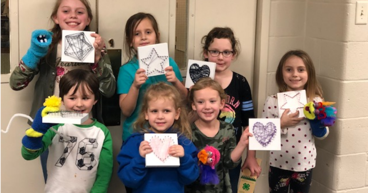 Flock of Friends 4-H club members posing with their crafts