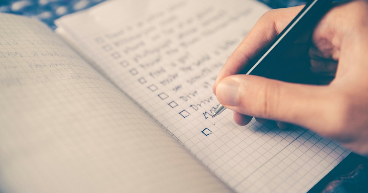 A photo of a person writing down their goals