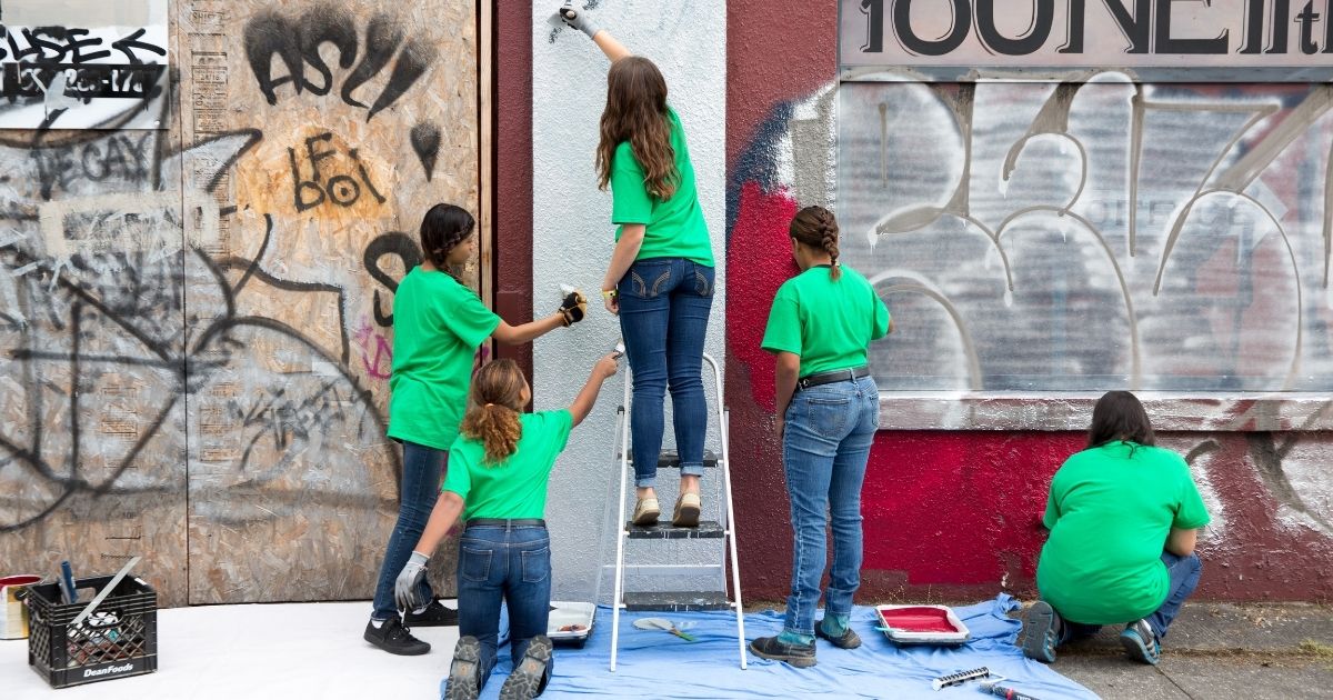 4-Hers volunteering to paint a wall