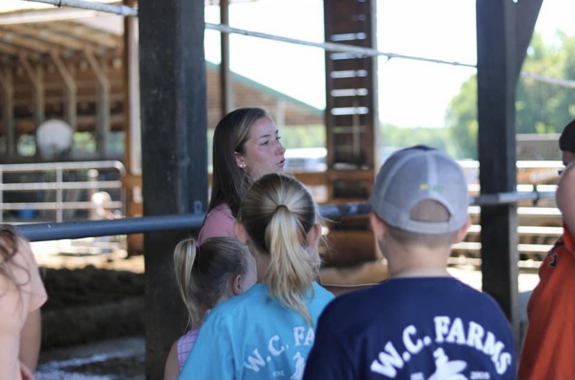 Bethany Knutsen, who grew up on a Delaware dairy farm, explains animal care to younger students. 