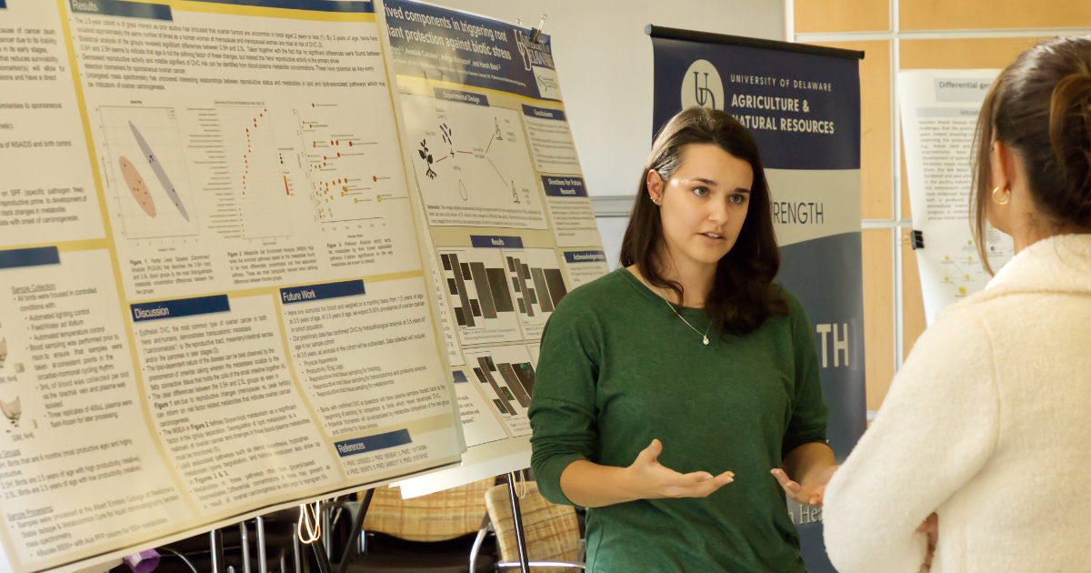 Kathryn Ellwood presents in front of her poster at the Fall 2022 College of Agriculture and Natural Resources Research Symposium.