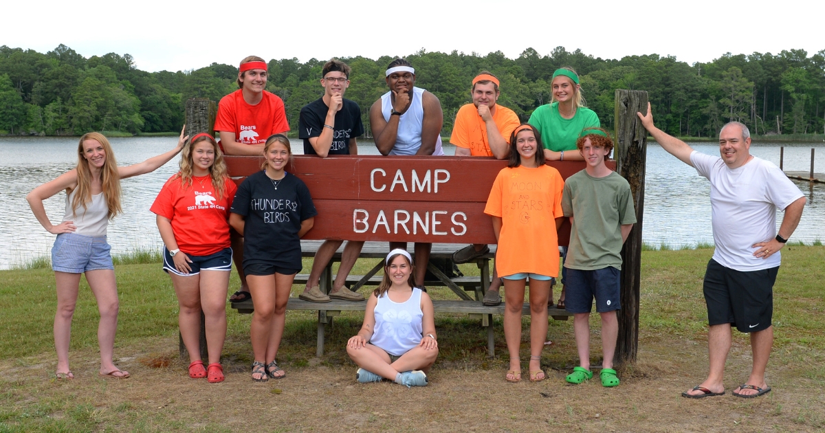 Voices and Echoes pose in front of the Camp Barnes sign in 2021